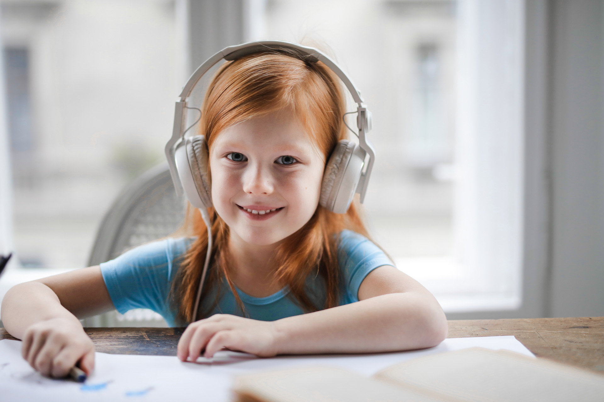 Young girl listening to online course