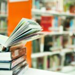 Stacked books on top of table
