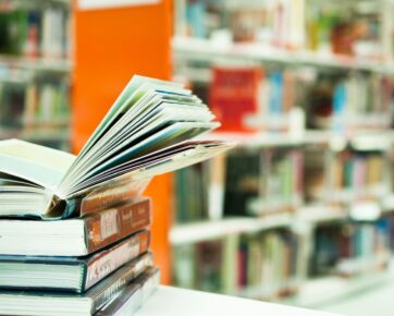 Stacked books on top of table