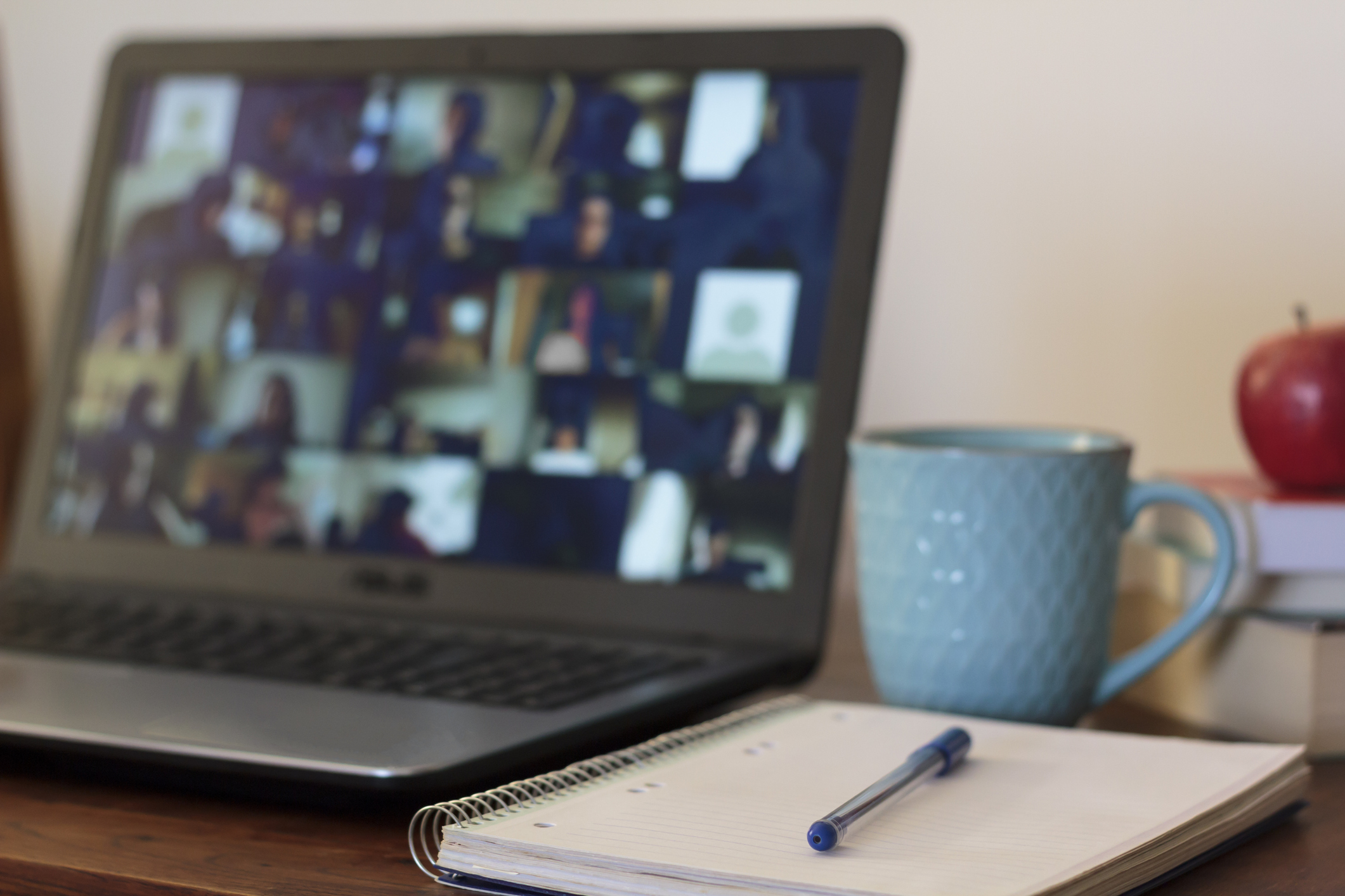 Laptop with live online classes and notebook on desk
