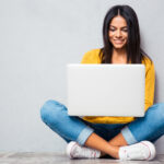 Woman sitting on the floor and using laptop