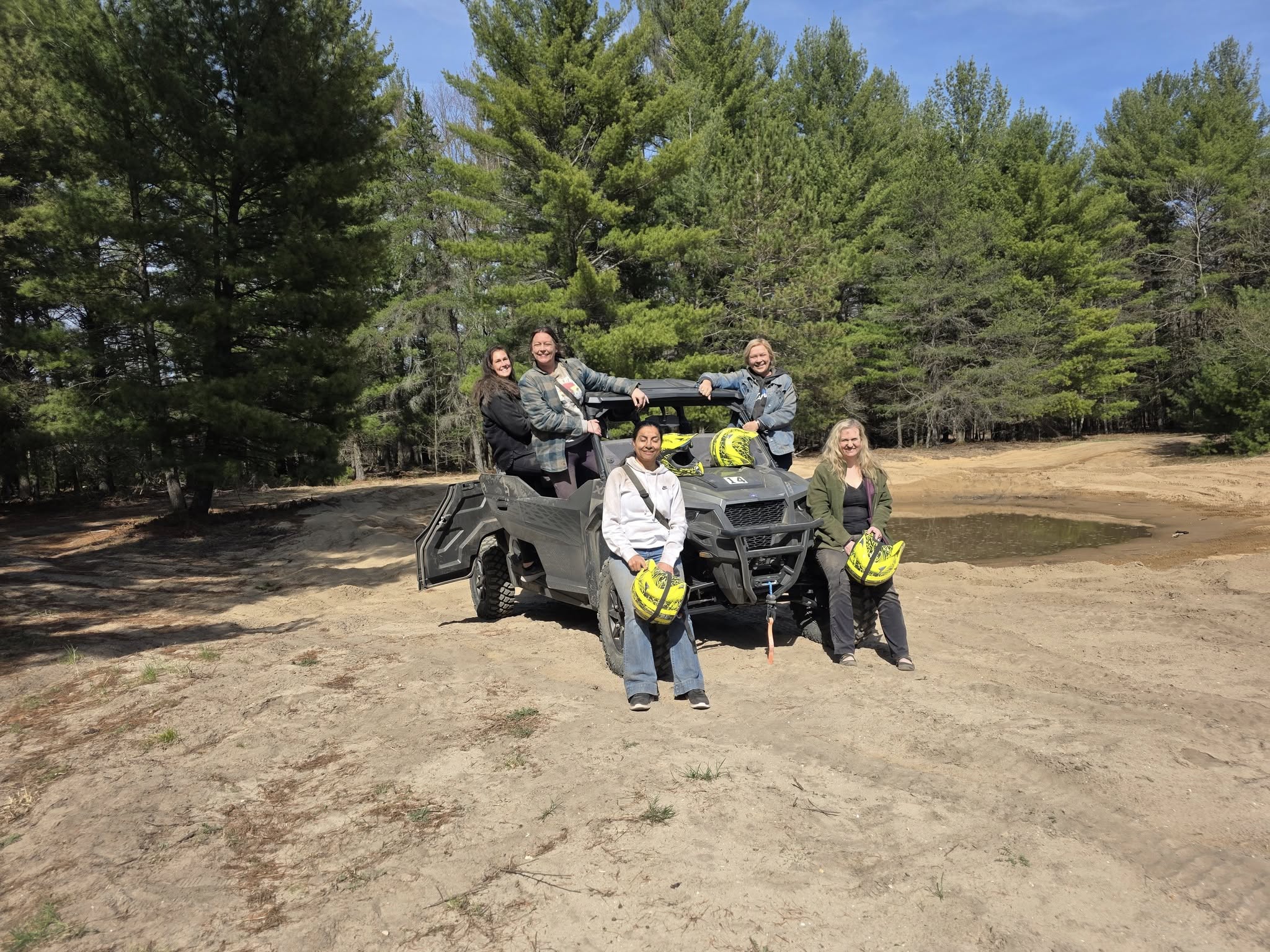 group of people in front of ATV